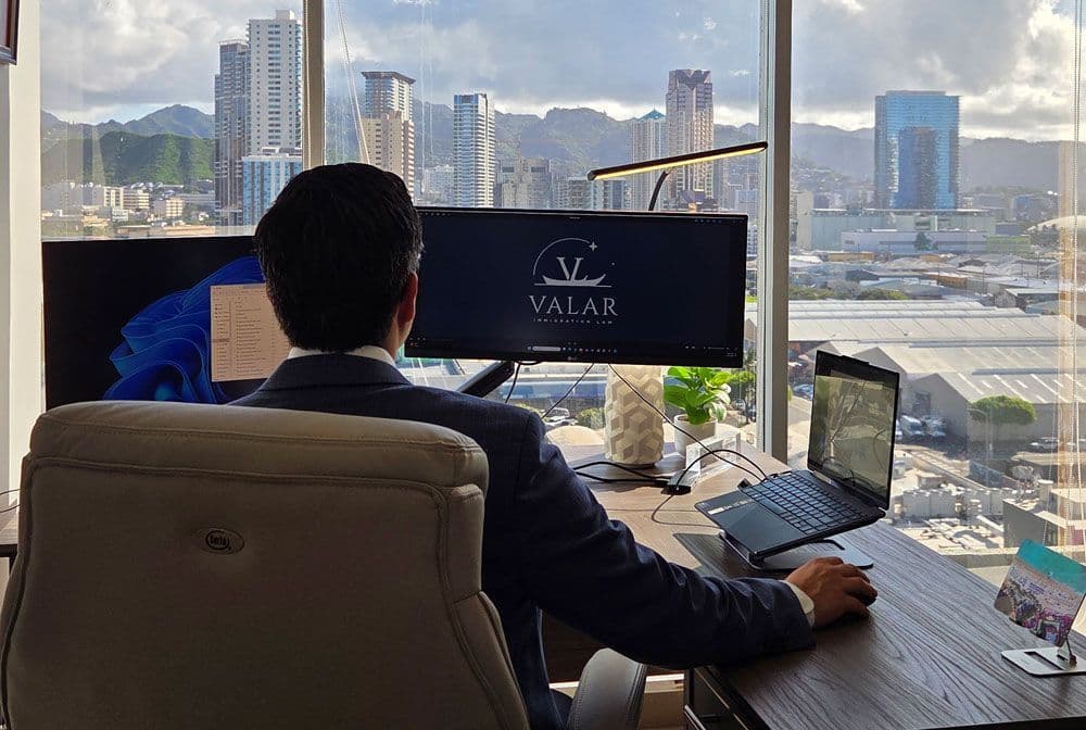 Honolulu immigration attorney looking out window in law office